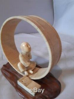 Antique Japanese okimono of a man seated within a handmade tub